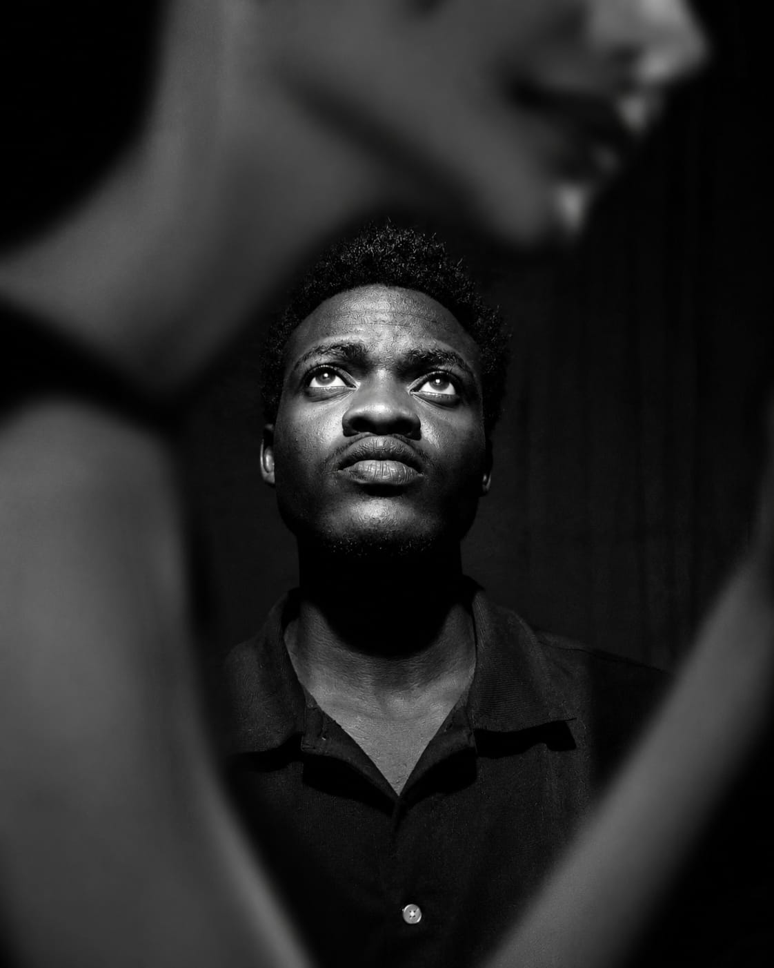 Joshua Nuru looking upward in a black and white portrait